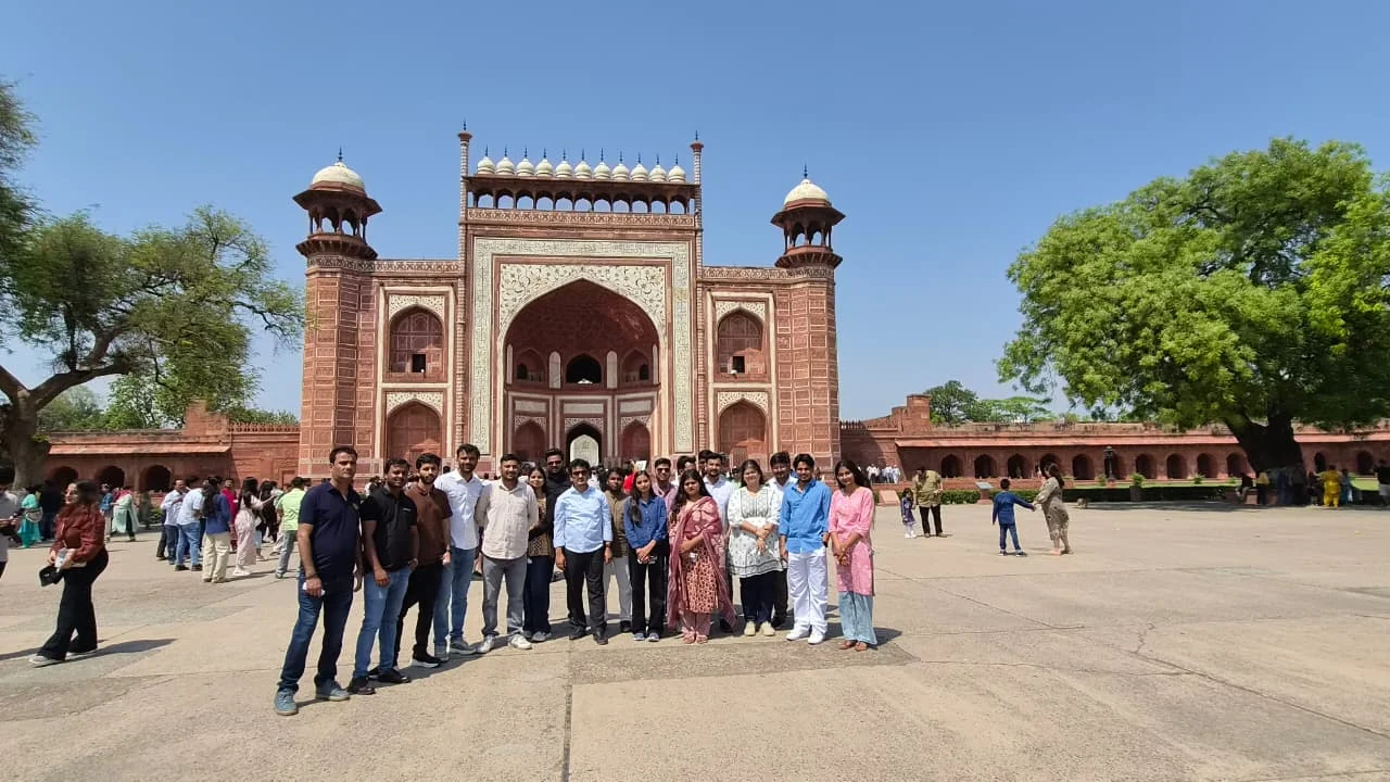 Team photo at historical monument gate